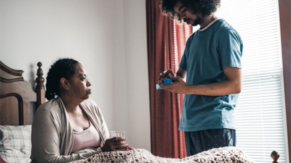 leah and her son aasad in the bedroom taking medication to help curb tobacco cravings