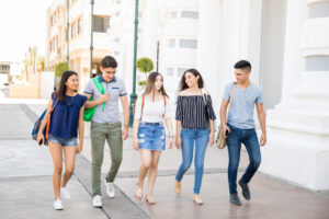 group of teenagers walking side by side down the street